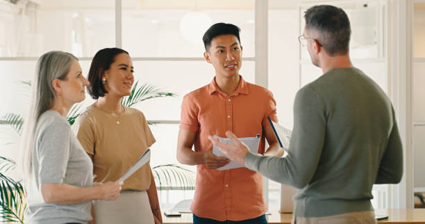 istock CEO, documents or business people in meeting planning a  startup project with boss coaching employees. Teamwork, senior mentor leadership or workers with paperwork data for our vision or sales goals 1477078611