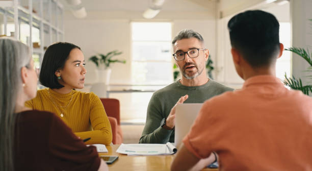 istock Strategy, CEO or business people in meeting planning a creative startup project in collaboration together. Teamwork, brainstorming or workers with paperwork for our vision, group ideas or sales goals 1477078612