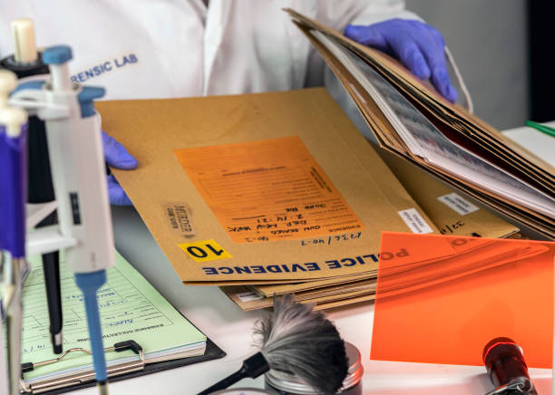 istock Police scientist searches for criminal file in crime lab, conceptual image 1477079007