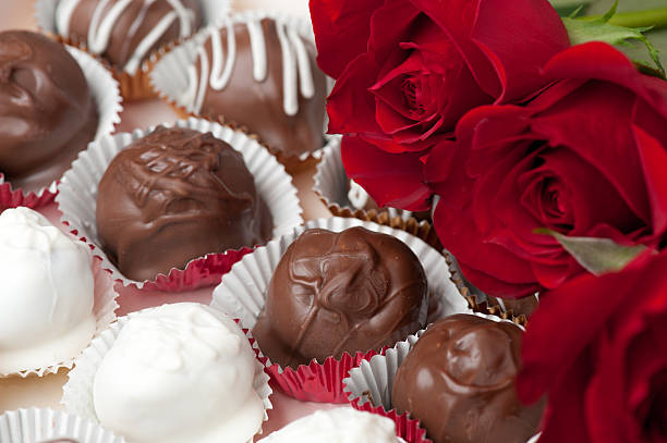 Chocolates and roses stock photo