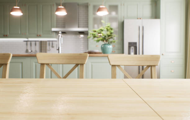 istock Green kitchen interior with island. Stylish kitchen with wooden worktops. Cozy olive kitchen with utensils and appliances. Close-up of a dining table in the background of the kitchen. 3D visualization 1477079097