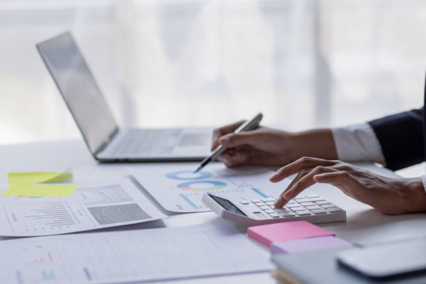istock Businessman accounting working at office with calculator documents on his desk, doing planning analyzing the financial report, business plan investment, accounting finance analysis concept 1477079552