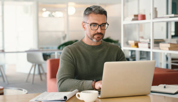 istock Remote work, email and a man typing on a laptop for communication, entrepreneurship and business. Serious, browsing and a freelance worker reading, planning and working on a computer at home 1477080007
