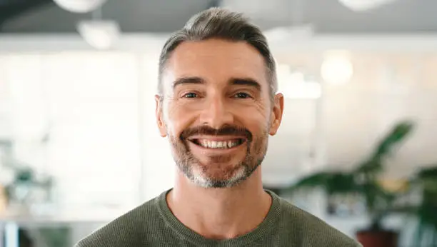 Photo of Man, entrepreneur and face, success in workplace and professional mindset at startup in portrait. Male smile in office, career growth and satisfaction with development and happiness at digital agency