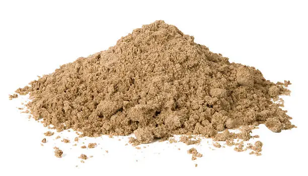 Photo of Small pile of loose sand against white background