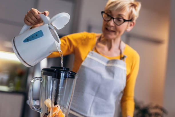 istock Senior woman preparing healthy juice 1477084807
