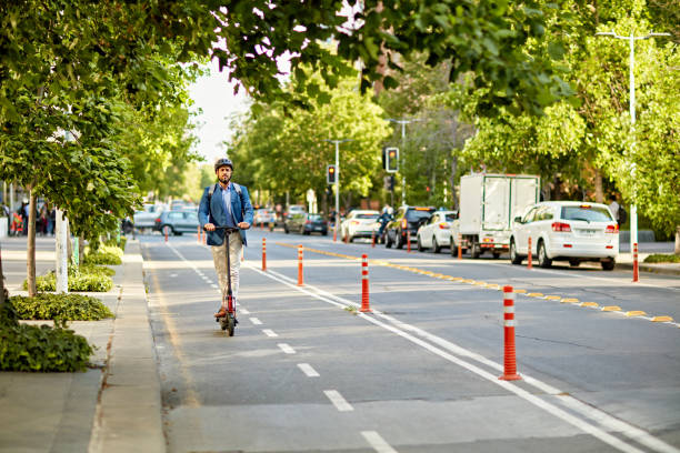istock Businessman riding to office on electric push scooter 1477085508