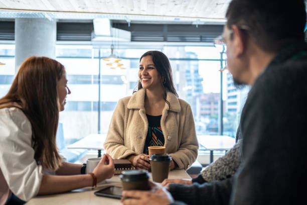 istock Coworkers talking after work in the coffee shop 1477085728