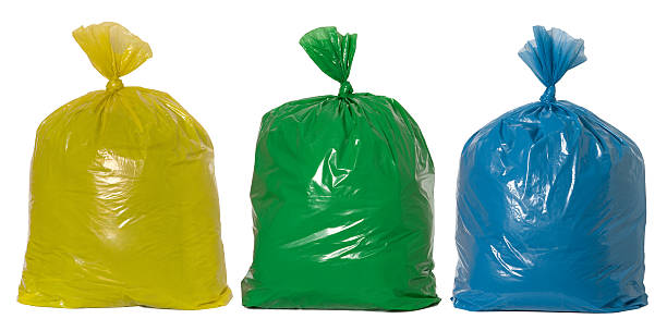 Rubbish ready for recycling Yellow, green and blue rubbish bags garbage bag stock pictures, royalty-free photos & images