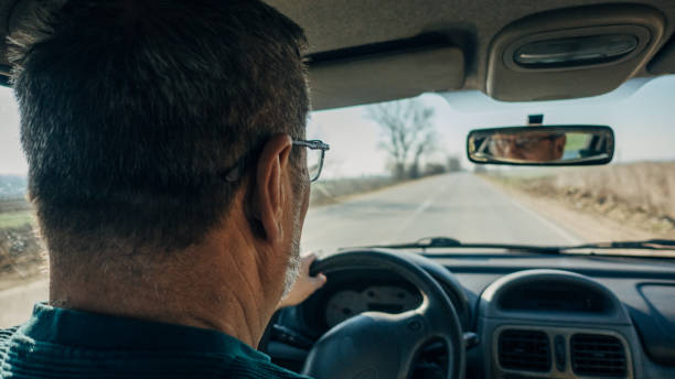 istock Road trip, an elderly man drives a car 1477088498
