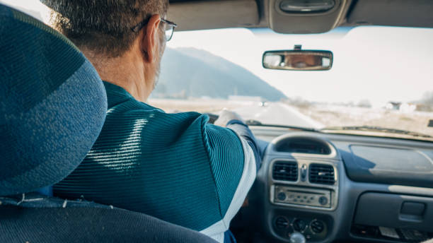 istock Road trip, an elderly man drives a car 1477088500