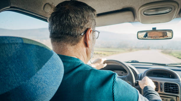 istock Road trip, an elderly man drives a car 1477088520
