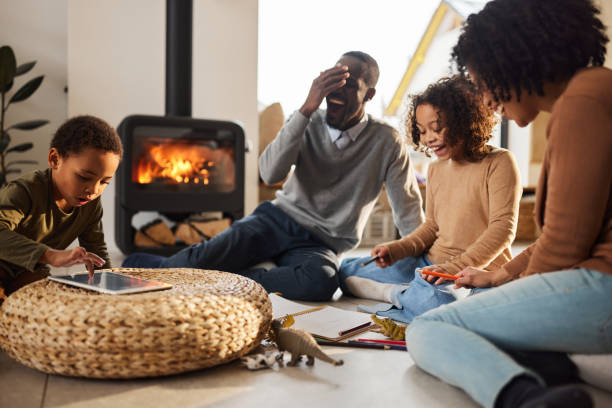 istock Cheerful black family having a creative time at home. 1477088649