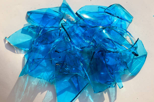 Broken glass was scattered on floor of home,cracked to small shattered and sharp,shards of glass and broom with dustpan,be careful when cleaning up,accident,careless,housework,housekeeping concept