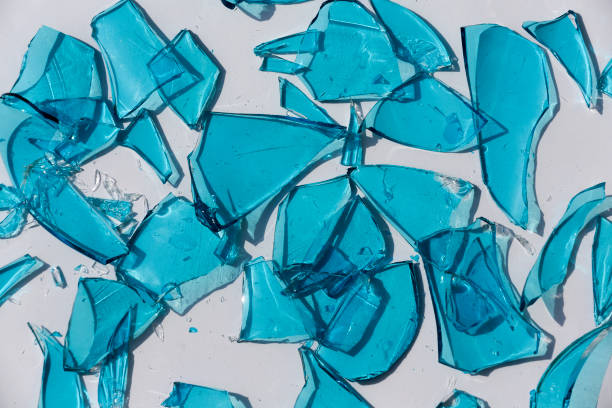 Broken Blue Glass isolated on white background Broken Blue Glass isolated on white background domestic violence india stock pictures, royalty-free photos & images