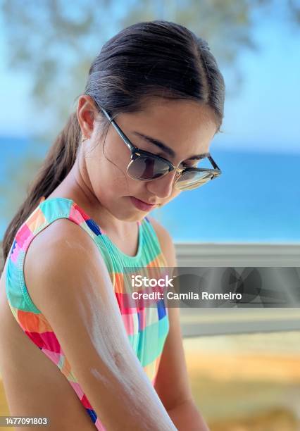 Beautiful Girl Applying Sunscreen Stock Photo - Download Image Now - 12-13 Years, Applying, Beach