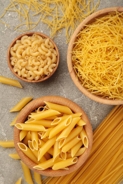 istock Various types of Italian pasta on grey background 1477093493