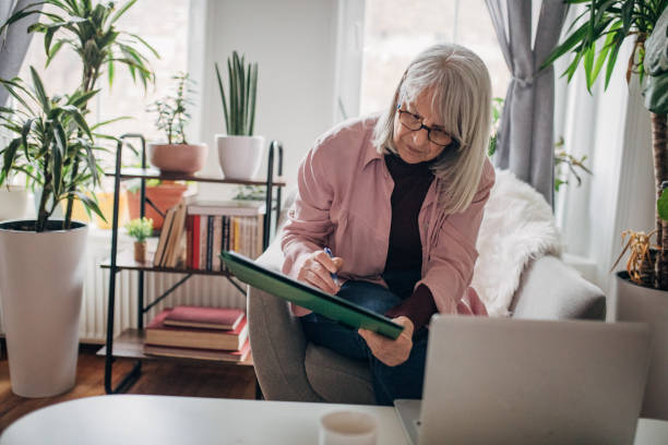 istock Modern senior woman using laptop 1477096886
