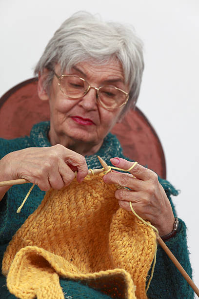 istock Old woman knitting 147709691