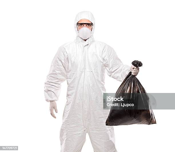 Photo libre de droit de Homme En Uniforme Tenant Un Sac Poubelle Noirs banque d'images et plus d'images libres de droit de Bleu de travail - Bleu de travail, Tenue de protection, Blanc