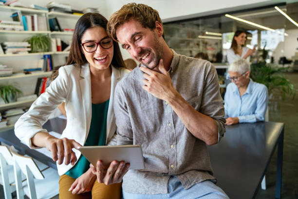 istock Smiling diverse colleagues gather in boardroom brainstorm discuss financial statistics together 1477099969