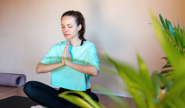istock Brunette woman meditating in lotus pose. 1477101492
