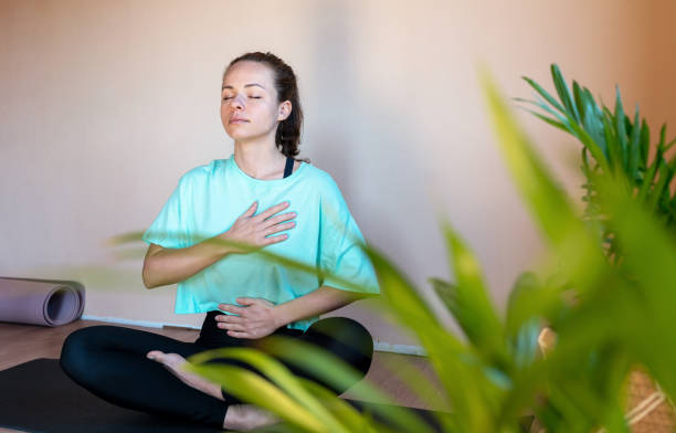 istock Woman doing yoga breathing exercise. 1477101546
