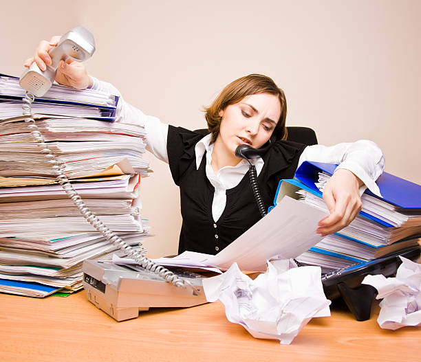 istock Young businesswoman with tons of documents 147710266