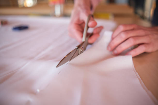 istock Cutting pieces of fabric with scissors 1477102810