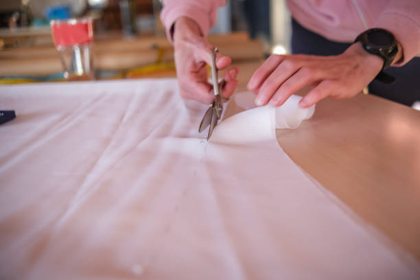 istock Cutting pieces of fabric with scissors 1477102812