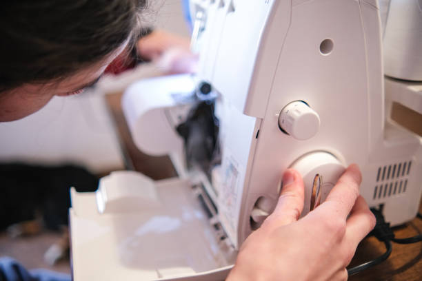 istock Fashion designer using a sewing machine to patch up a fabric 1477102931