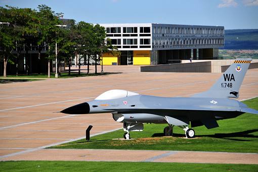 Colorado Springs, Colorado, USA: United States Air Force Academy / USAFA - General Dynamics F-16A Fighting Falcon Nr 75-0748 on static display outside Vandenberg Hall - test bed aircraft in the colors of Nellis Air Force Base, Nevada (WA). The F-16 Fighting Falcon is a US-made single-engine multi-role fighter aircraft. The single-seat machine was originally developed by General Dynamics for the US Air Force and has been produced by Lockheed Martin since 1993. Initially, the F-16 was only designed as a light fighter, but the high demand led to its further development as an all-weather, multi-role fighter.