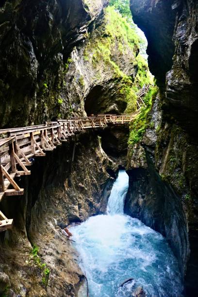 The Sigmund Thun Gorge is located near the village of Kaprun and is one of the most beautiful natural sights of the holiday region around Zell am See. Wooden bridges and stairs along the gorge. Wooden passages on the wall of the gorge above the boiling water. Turquoise water in the gorge and rustic passages on the rock. 8571 stock pictures, royalty-free photos & images