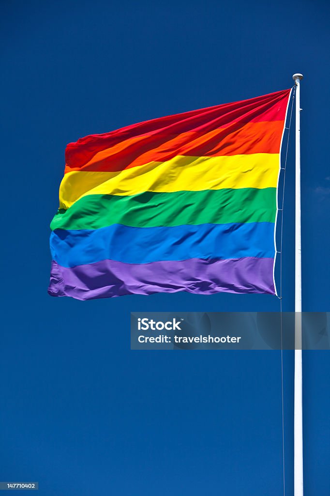 Gay Pride Flag, fluttering in wind Rainbow / LGBT / Gay Pride Flag, Zurich, Switzerland. Blue Stock Photo