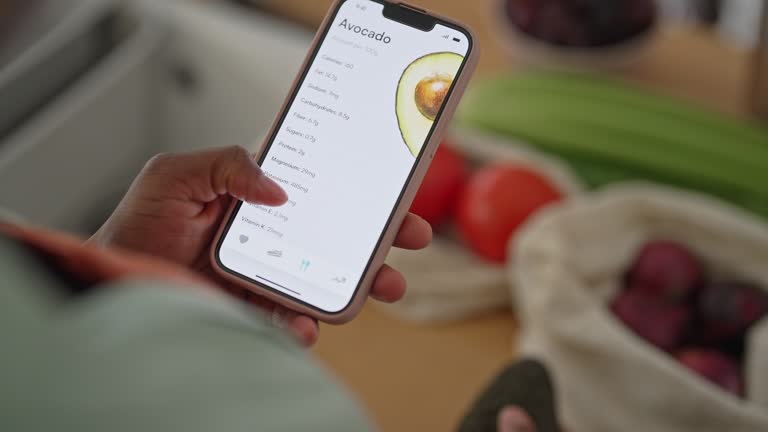 Close up of a woman holding smartphone with health app on the screen