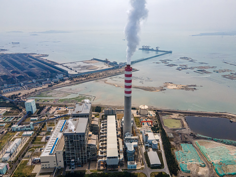 A bird's-eye view of a thermal power plant by the sea