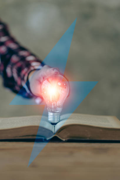 istock Hand holding a light bulb. Innovation and inspirational concept, businessman holding light bulb hand with financial documents and new concept tools for business and finance. 1477109109