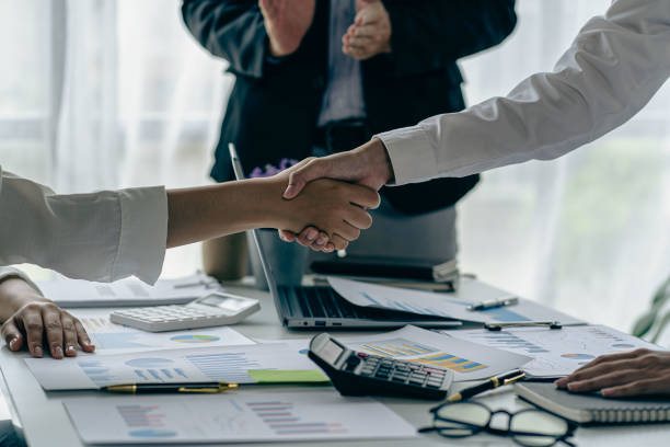 istock Two confident businessmen shaking hands during meeting in office Successful collaboration and contact Greetings and Partnerships in the Real Estate Business 1477109142