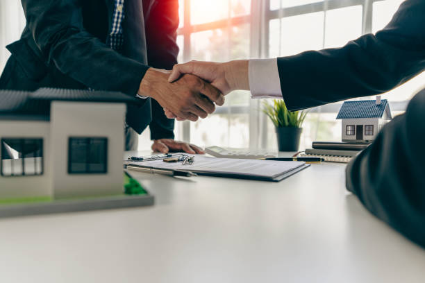 agent, lease, successful management
Real estate brokerage manager shaking hands with client after signing home purchase contract in real estate agency office