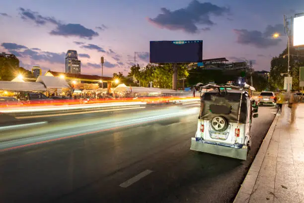 Photo of Tuk tuks wait outside Phnom Penh Night Market,at dusk,Cambodia,South east Asia.