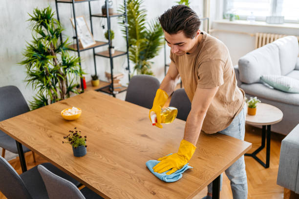 istock Young Man Cleaning His Dining Table At Home 1477111731