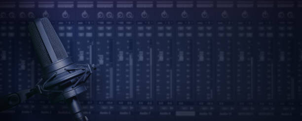 Vocal microphone with mixing screen device background for music production or radio broadcast banner with copy space