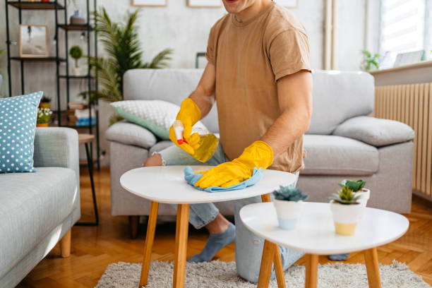 istock Young Man Cleaning His Coffee Table At Home 1477112799