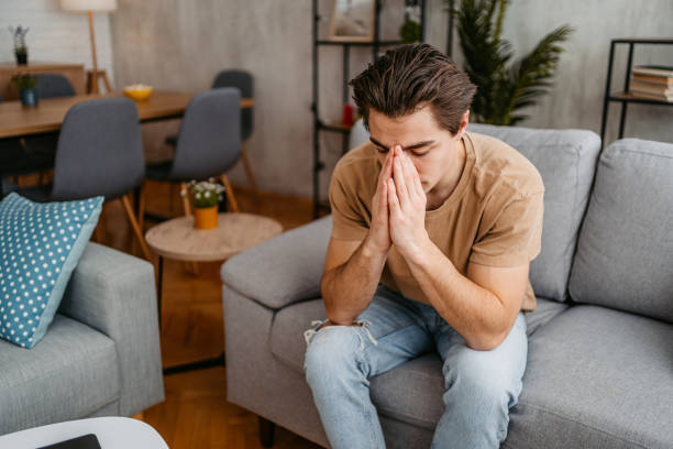 istock Sad Young Man Sitting At Home On The Sofa 1477114649