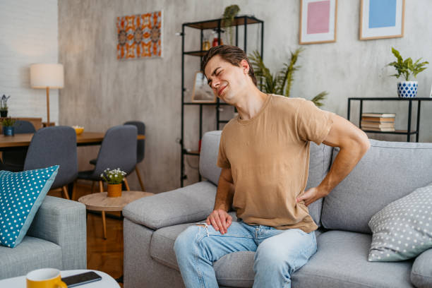 istock Young Man Having Back Pain At Home 1477115290