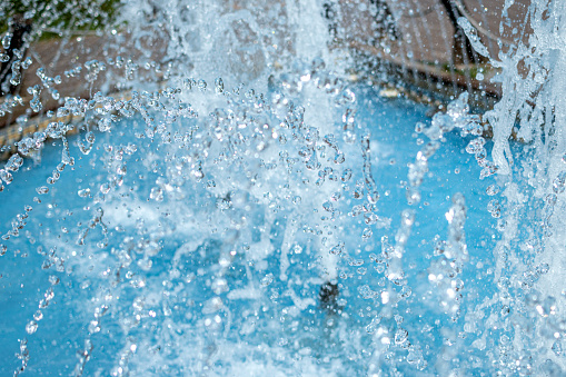 The water waves in the swimming pool were streaks of bright blue and there is a fountain