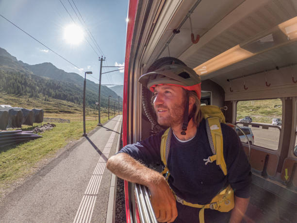 istock Mountain biker on Swiss train getting a ride up the mountain 1477117088