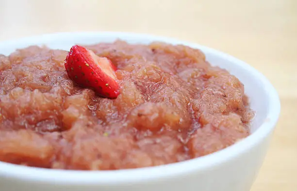 Close up of strawberry applesauce in a white bowl