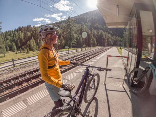 Woman with mountain bike waiting for public transportation