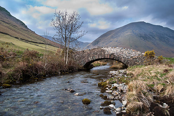 istock Mountain Stream flowing under a stone bridge 147711778